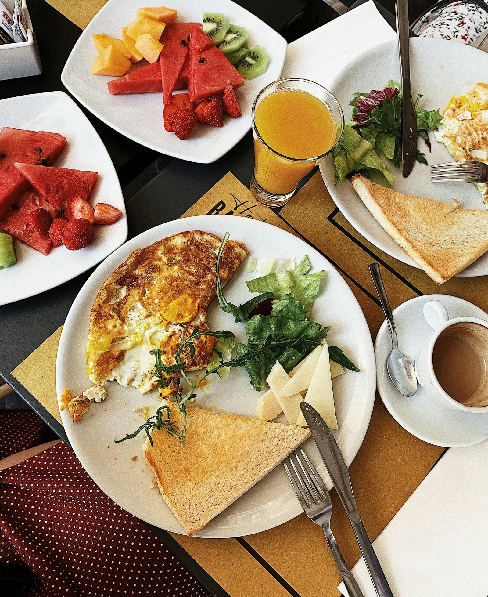 Delicious brunch spread featuring omelette, toast, and fresh fruits in Rome, Italy.