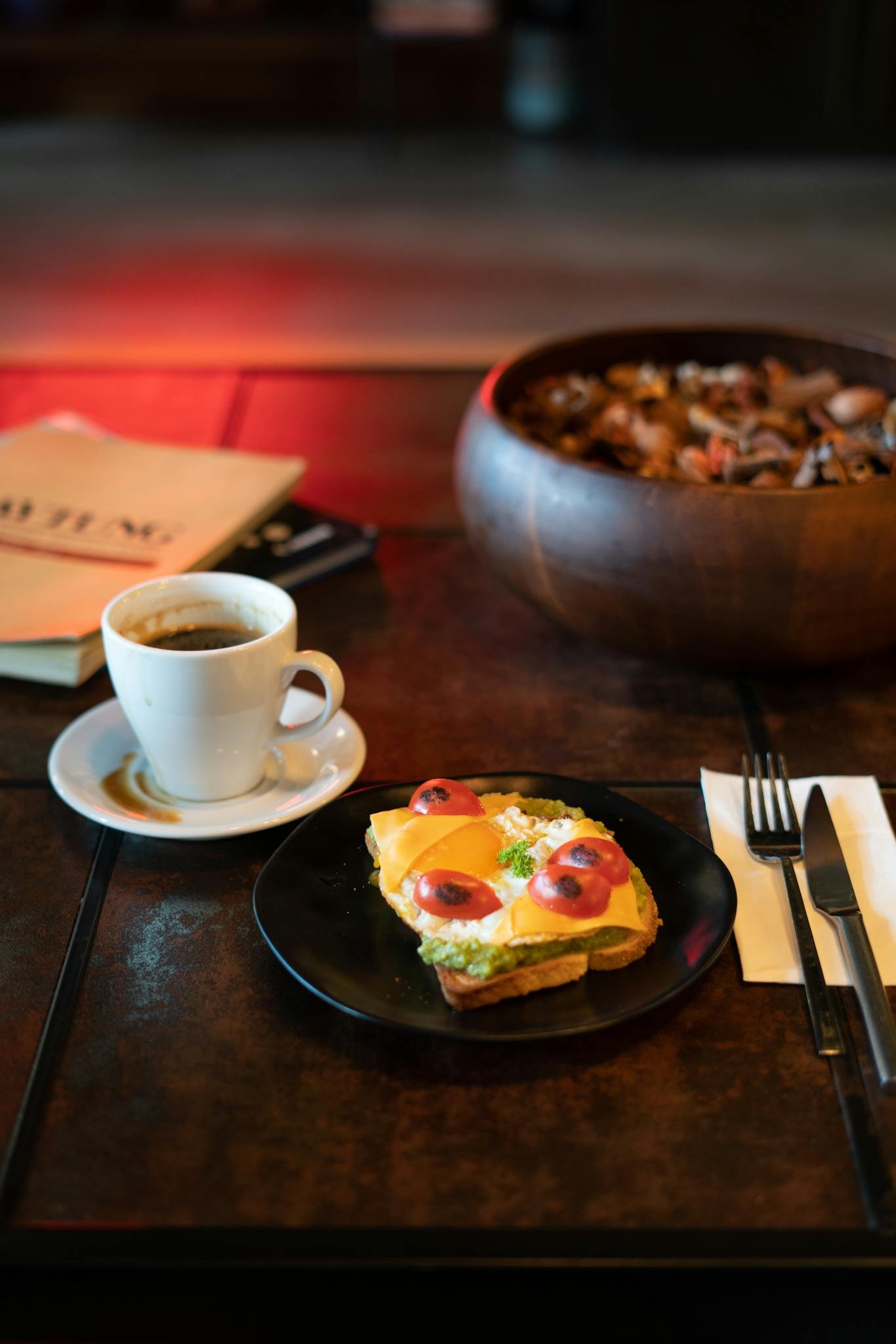 Tasty avocado toast with coffee served on rustic table, perfect for brunch.